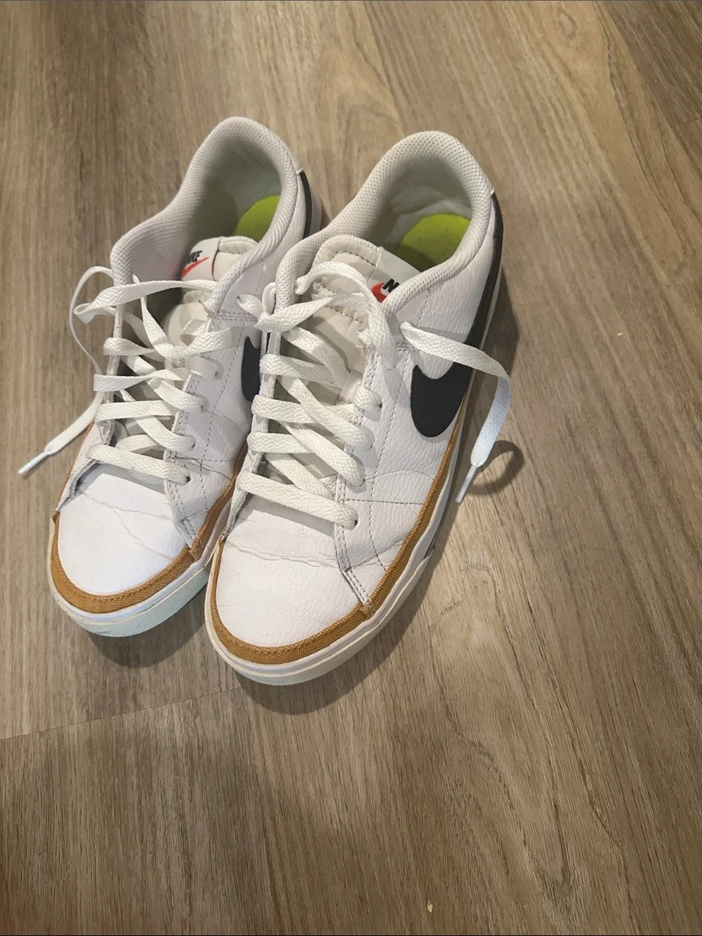 Nike White Low-Top Sneakers with Black Swoosh and Tan Trim court legacy